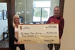 Waldo State Bank's employee, Sherry, with donation to the Mill Pond Association.