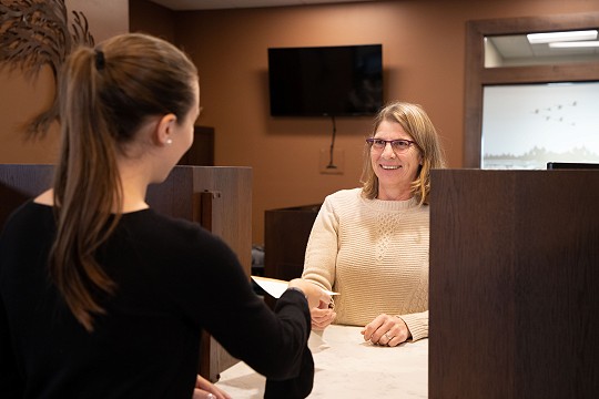 A young female interacts with a Waldo State Bank team member.