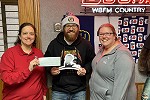 Waldo State Bank employees donating to St. Jude at radio station B93.7